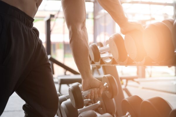 Strength and Conditioning Training: young man execute exercise in fitness center