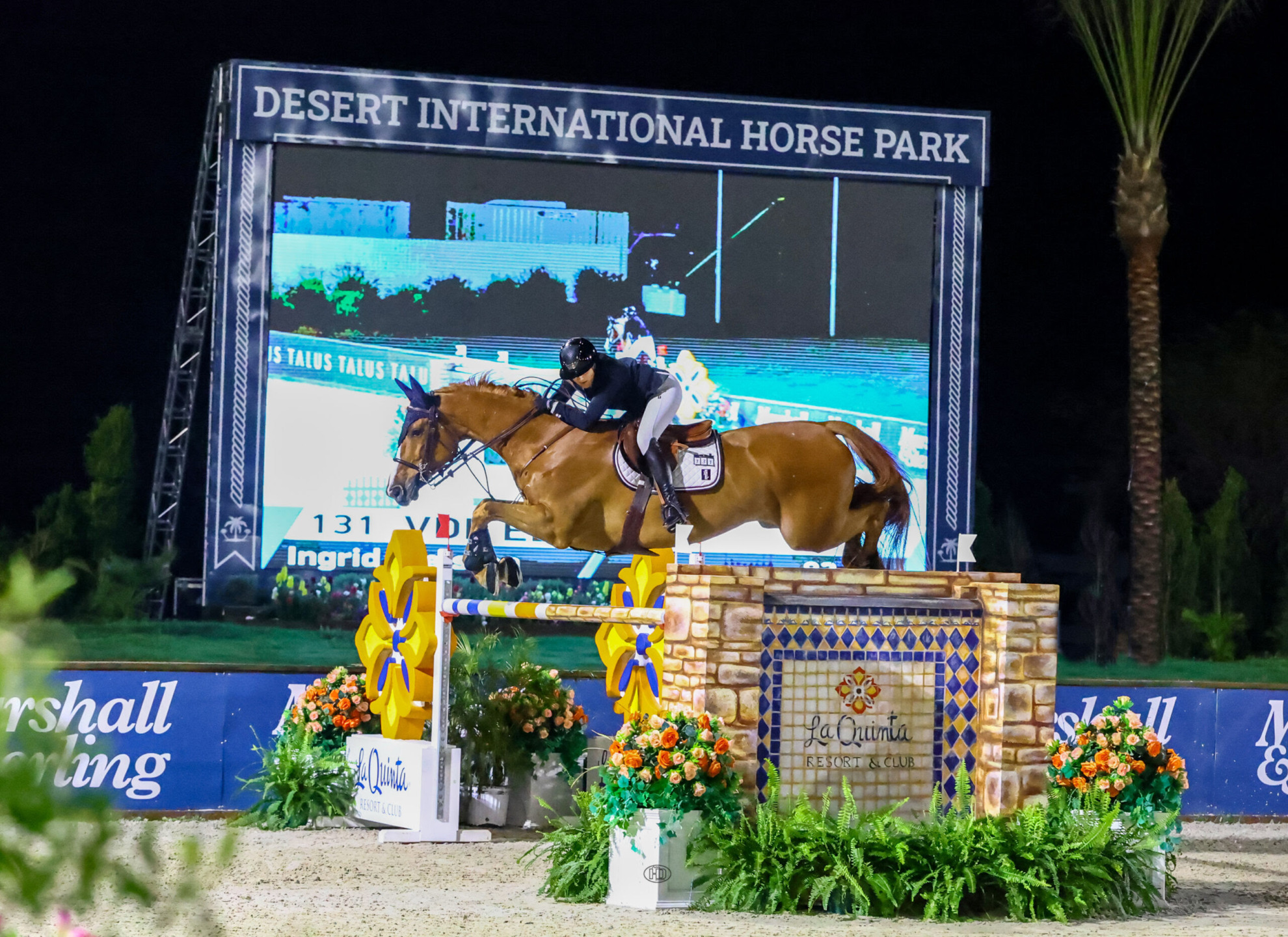 Ingrid Gjelsten (NOR) atop the podium in her winning presentation won the CSI4* Grand Prix at Desert Circuit